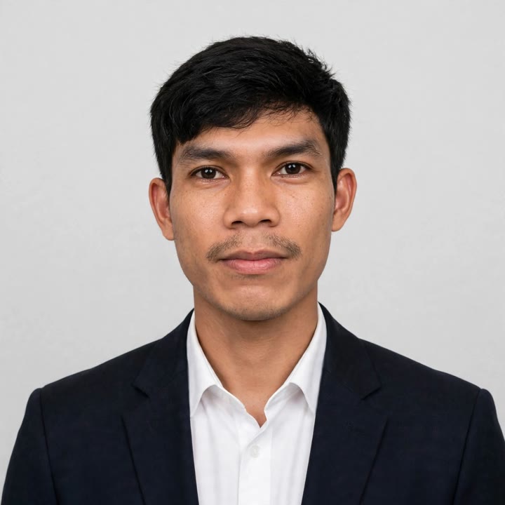 Portrait of Lito M. Abrenica in a dark blazer and white shirt